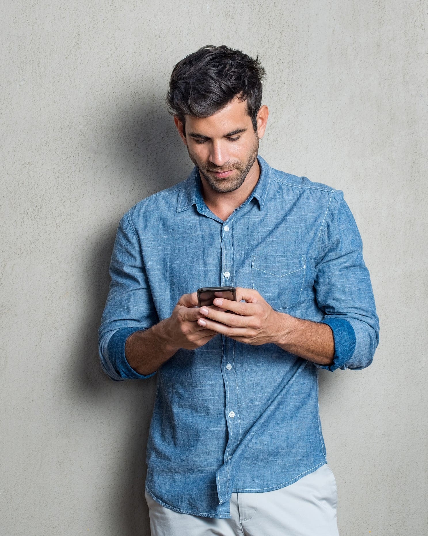 bigstock-Young-man-writing-phone-messag-206291725